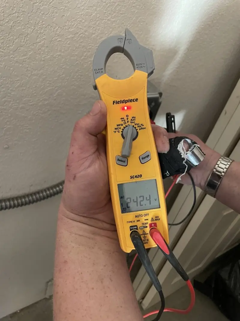 Voltage testing with clamp meter during Electrical Installation Services in Lorton